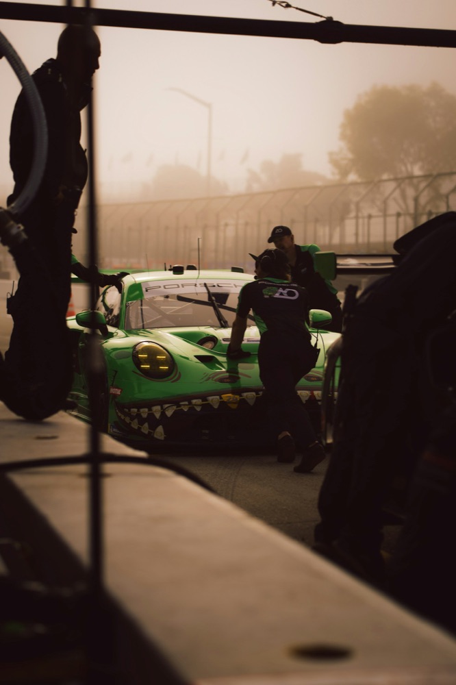 A pit crew working together on a race car